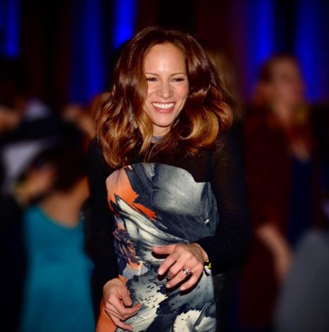 Exton Downey's mother Susan Downey smiling in a blue dress